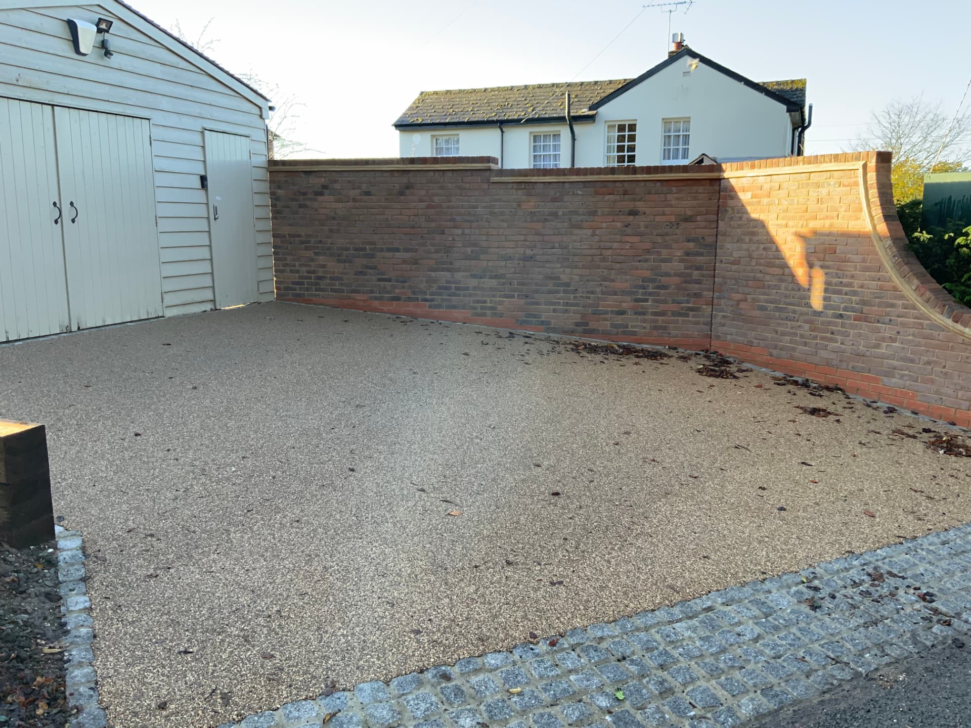 Gravel drive and brick wall